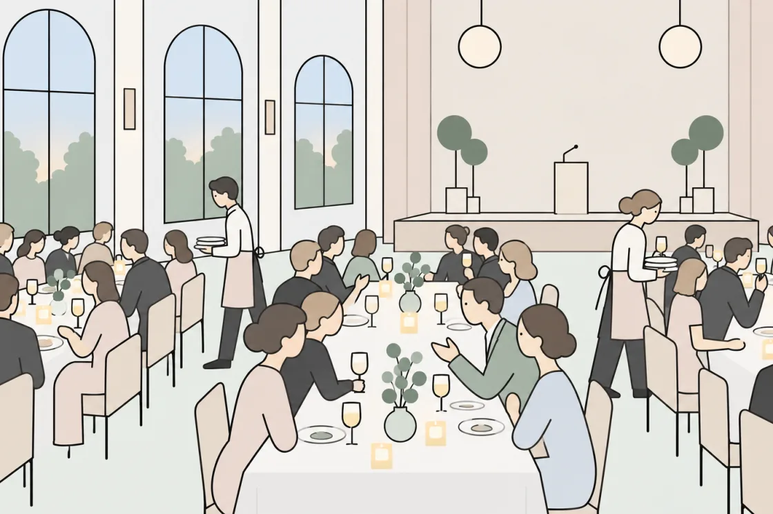 Guests sit at the laid tables while the service staff bring the plates